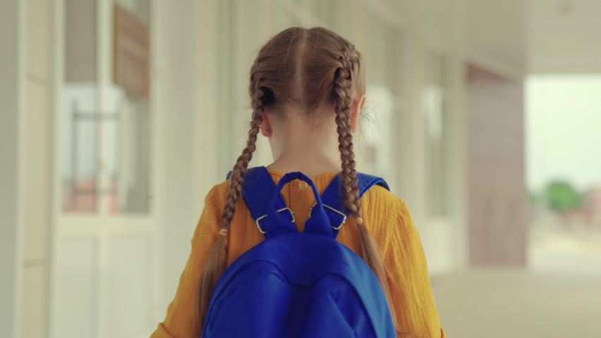 Child goes to school, education. Little schoolgirl daughter with backpack enters school building. Future belongs to children. Little girl with backpack goes to school. Children education concept. | Shutterstock HD Video #1091655335