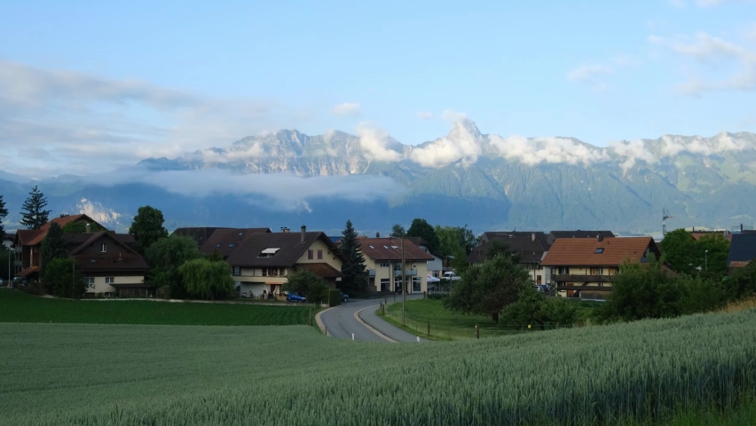 A footage with noise effect of wheat farm with small town of steffisburg and Stockhorn Mountain insight.