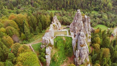 Aerial drone view of famous Tustan fortress. Ukrainian medieval cliff-side monument in national park. Rock complex of Tustan is popular tourist landmark in Carpathians mountains. Ukraine, Lviv oblast