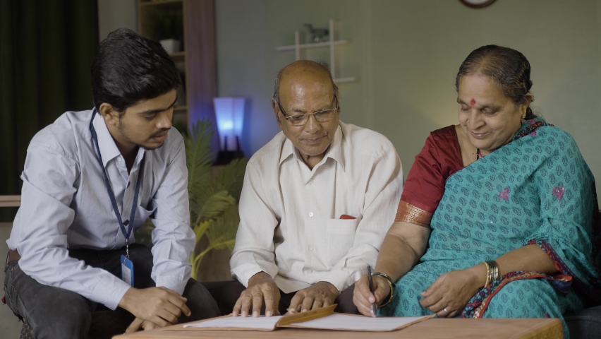 Senior couple signing insurance documents from bank officer at home - concepts of financial support, banking and investment | Shutterstock HD Video #1091661445