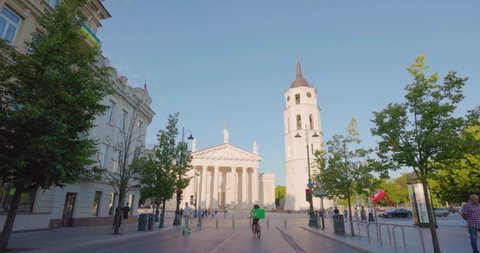 JUNE 25, 2022: Vilnius Cathedral Basilica with tourists walking in the streets