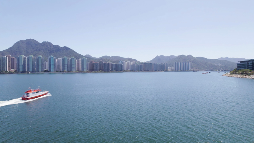 Aerial shot of a boat driving in Tolo Harbor, Hong Kong at sunny day