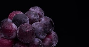 Videotaping large grapes on a rotating table.
Black background.
A variety called 