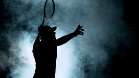 Super slow motion of tennis player silhouette hitting ball. Smoke effect around, black background. Filmed on high speed cinema camera, 1000fps. - Powered by Shutterstock - Get 15% off with code: PIKWIZARD15