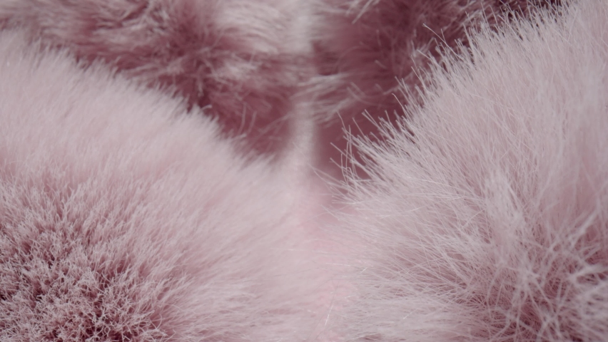 Texture of soft fluffy pink fur fabric. Faux hairy fur. Fluffy fake fur clothes, furry blanket. The camera moves through the hairs of fur. Textile shaggy fiber close up. Fashion industry textile. Royalty-Free Stock Footage #1091672183