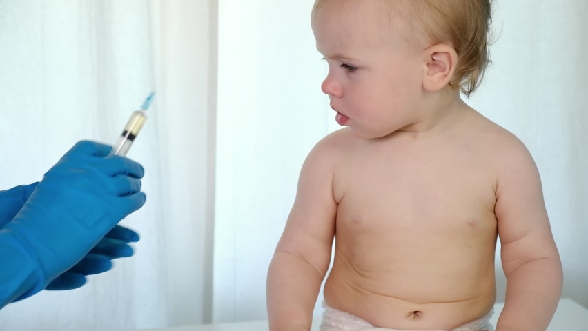 Doctor vaccinating crying baby in clinic. Little baby get an injection. Pediatrician vaccinating newborn baby. Vaccine for infant child. Child's Immunization, Children's Vaccination, Health concept | Shutterstock HD Video #1091672413