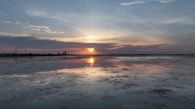 Reverse reveal of sunset over Mobile Bay and the City of Mobile, Alabama