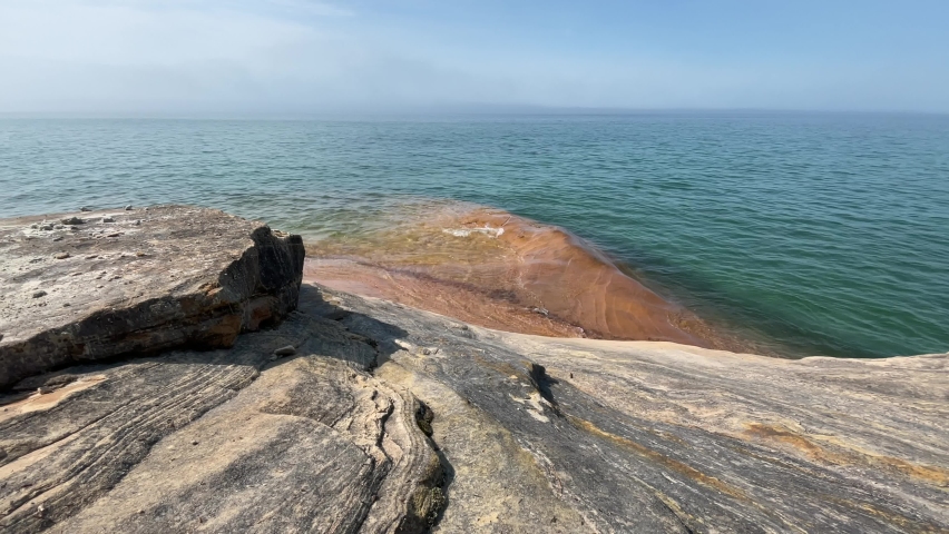 Waves Rolling Over Pictured Rocks Lake Michigan Blue Water Coast on Sunny Day