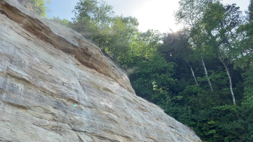 Huge Rock Formation Cliff With Trees Pictured Rocks on Sunny Day Light Beaming Through Trees Some Fog Michigan Munising