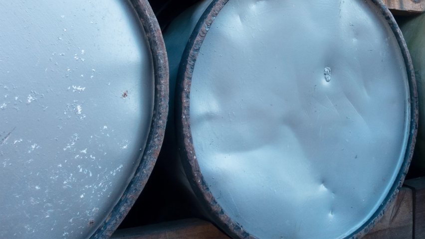 Panning of stack of vintage oil barrels