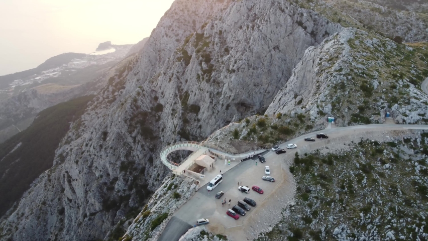 Skywalk on the mountain Biokovo aerial top view. Skywalk glass observation bridge over mountains and Adriatic sea at sunset. Makarska riviera Croatia. High quality footage 4k. Royalty-Free Stock Footage #1091678685