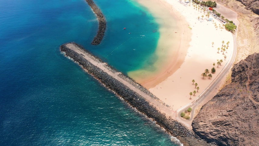 4K drone aerial shot of Playa de Las Teresitas, artificial gold sand beach, the most beautiful beach in Tenerife, Canary Islands