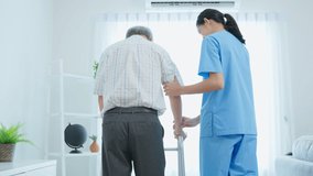 Asian senior elderly man patient doing physical therapy with caregiver. Attractive specialist carer women help and support older mature male practice walking slowly with walker at nursing home care. - Powered by Shutterstock - Get 15% off with code: PIKWIZARD15