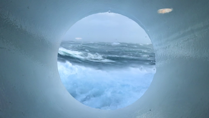 A view of a storm in the ocean from the porthole of a going ship. A ship in the ocean during a storm. View of ocean waves from a cruise ship cabin.
 Royalty-Free Stock Footage #1091683991
