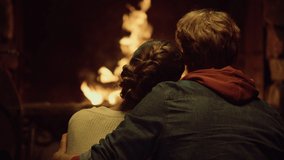 Romantic couple embrace cuddle on love date. Two lovers enjoy look fireplace back view. Caring unknown boyfriend girlfriend hug together on winter holiday vacation close up. Relax love married concept - Powered by Shutterstock - Get 15% off with code: PIKWIZARD15