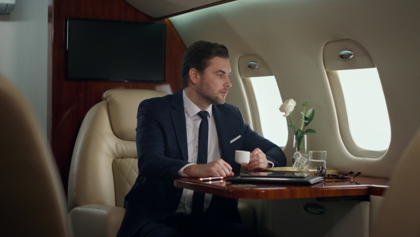 Smiling ceo posing alone at airplane window. Successful man enjoy corporate trip looking portrait. Confident stylish businessman flying luxury first class in suit. Elegant gentleman resting on journey Royalty-Free Stock Footage #1091685133