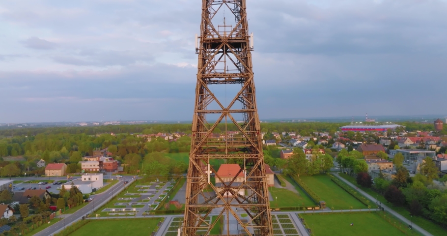 Aerial view of the wooden broadcasting tower in Gliwice with the city of Gliwice in the background. The concept of the largest wooden tower in the world. Wooden construction from a drone.