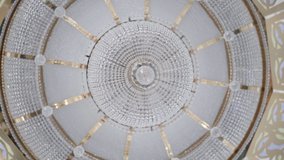 Bottom view of dome with crystal chandelier. Scene. Beautiful bright dome inside temple. Domed vault with crystal chandelier at top - Powered by Shutterstock - Get 15% off with code: PIKWIZARD15