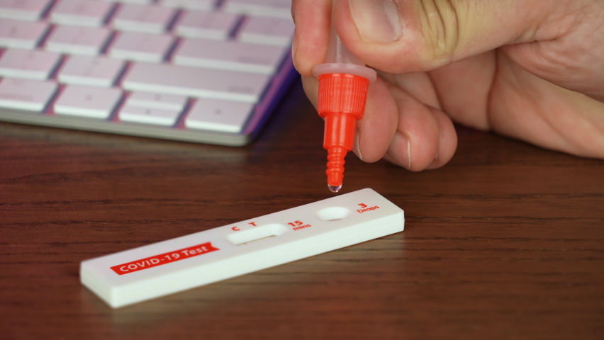 A man performs an at-home COVID-19 
 rapid antigen test at his desk.	 Royalty-Free Stock Footage #1091687017
