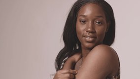 Stunning african american young girl smiling posing hug herself. Skincare cosmetics advertising. Self love.