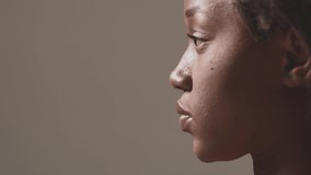 Profile of african american female face. Pensive focused black woman, close-up studio portrait, copy space.