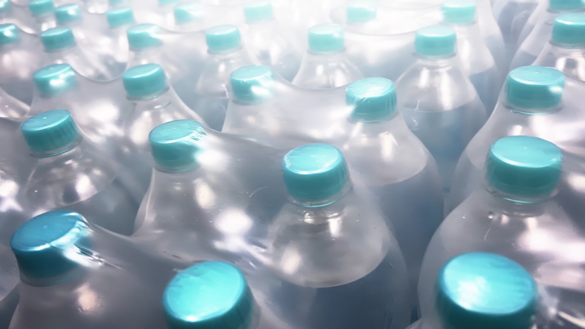 Two-liter bottles of mineral water packed in 6 bottles stand in warehouse. Close-up shot. | Shutterstock HD Video #1091692939