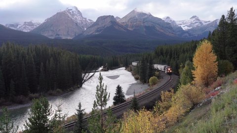 Banff, Alberta, Canada- 25 September 2021: Morant's curve in Bow Valley, Banff National Park. Iconic landscape and Canadian Pacific railway system in the Rocky Mountains of North America. Cargo train 