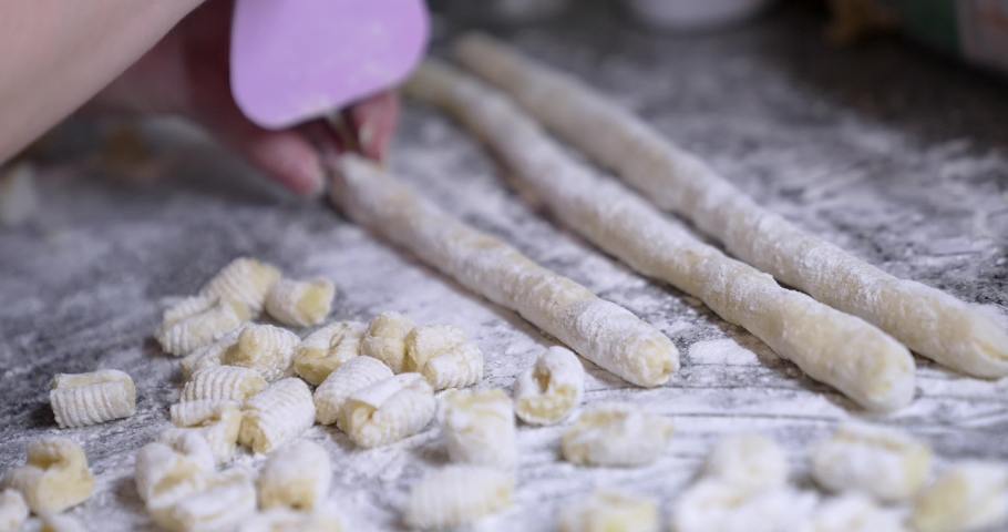 Woman making homemade pasta or sticks. Close up hands kneading the dough and making potato gnocchi by rolling the piece of dough on surface. Cooking a potato gnocchi.
Bolognese plate sauce with meat. | Shutterstock HD Video #1091694853