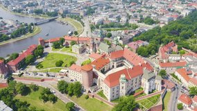 Inscription on video. Krakow, Poland. Wawel Castle. Ships on the Vistula River. View of the historic center. Arises from blue water, Aerial View, Departure of the camera
