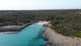 4k aerial video of the impressive landscape of turquoise waters Cala Des Talaier, in Menorca, Balearic Islands. A paradise of turquoise blue waters with incredible beaches and cove, Mitjana, Macarella