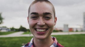 Shaved head girl smiling in front camera  - Powered by Shutterstock - Get 15% off with code: PIKWIZARD15