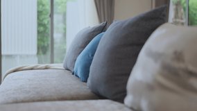dolly shot of close up soft pillows cushion arrange on sofa couch with blur garden view with transparent curtain sheer in living room home interior design concept - Powered by Shutterstock - Get 15% off with code: PIKWIZARD15
