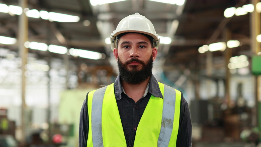 Portrait Professional mechanical engineering hispanic male in white safety hard hat helmet and look at camera at metal factory. Royalty-Free Stock Footage #1091709043