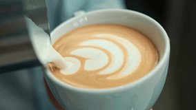 Barista making latte art in specialty coffee shop. Professional man making pouring stream milk with espresso - Powered by Shutterstock - Get 15% off with code: PIKWIZARD15