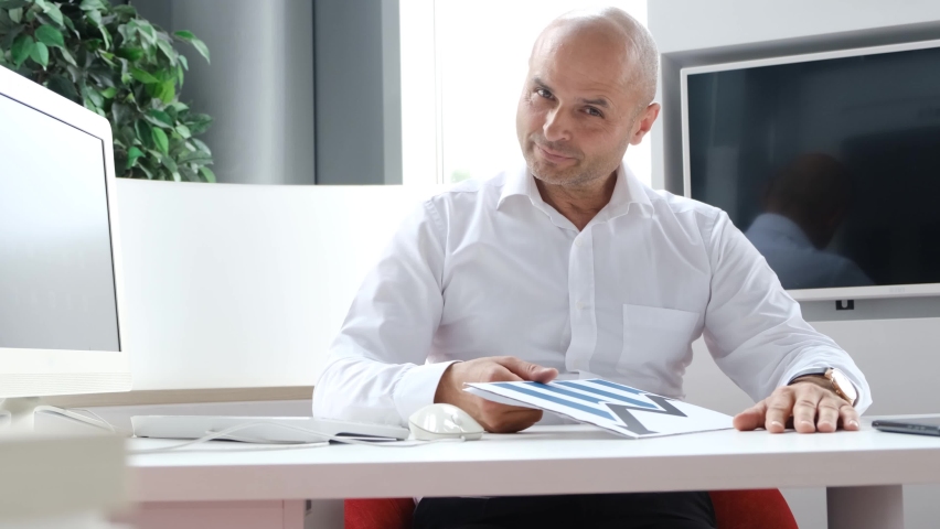 Portrait of a European broker sitting in the office. Businessman working in the office. 
