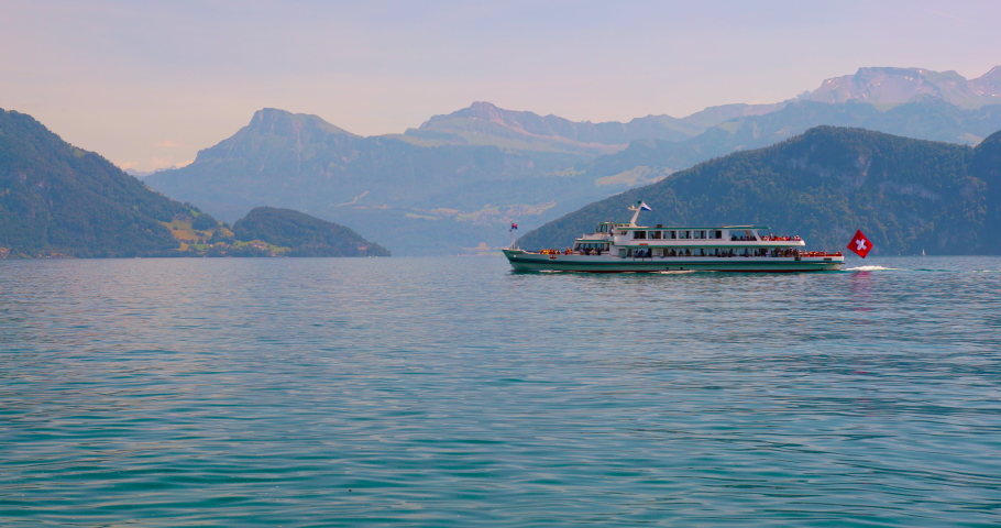 Cruise ship with tourists on the background of the Alpine mountains on Lake Lucerne in Switzerland. Royalty-Free Stock Footage #1091720043