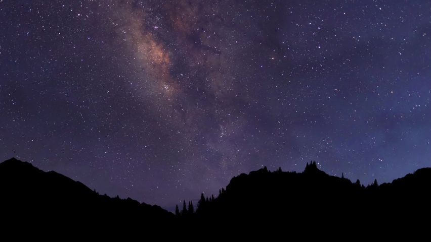 Night time lapse. The Milky Way Galaxy moving over the mountain ridge. Starry night background | Shutterstock HD Video #1091722569