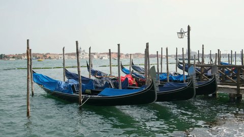 Historical gondolas parked on lagoon dock in Venice city center,Traditional water transportation,italy
