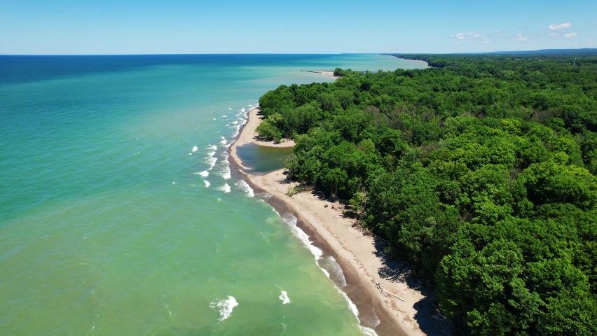 Spectacular Aerial drone video footage of beautiful Lake Erie during summer on a sunny day