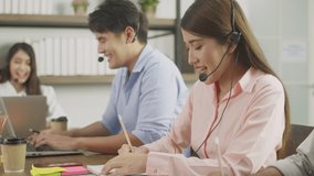 Asian group of call centers team working to customer service online in an office. - Powered by Shutterstock - Get 15% off with code: PIKWIZARD15