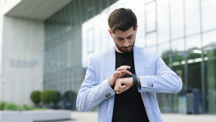 Businessman Scrolling On Display On Smartwatch Notification. Bearded Man Using Smart Watch Wearable Wristband Device. Male Checking Pulse Smartwatch App. Touch Screen Wearable Technology Smart Band. - Powered by Shutterstock - Get 15% off with code: PIKWIZARD15