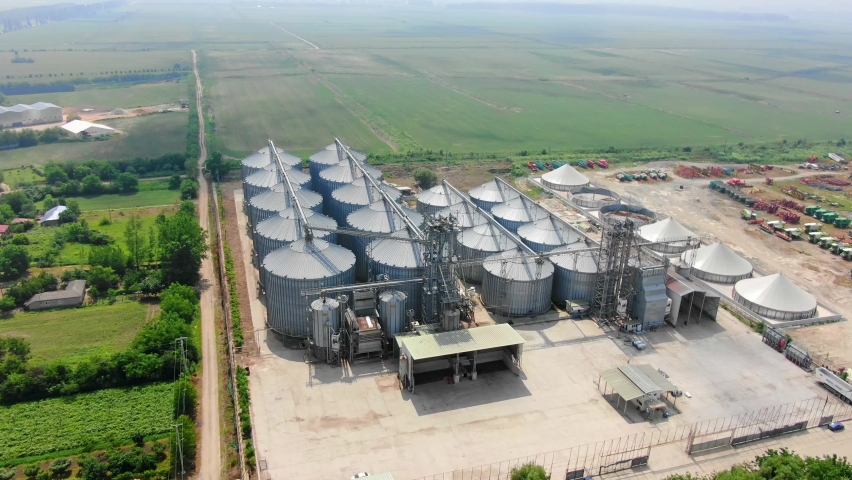Aerial view drone group of silo on a sunny day seen from above increase of storage price and food inflation silos for storage grain barley, oat, wheat food storage agriculture zoom in food factory
