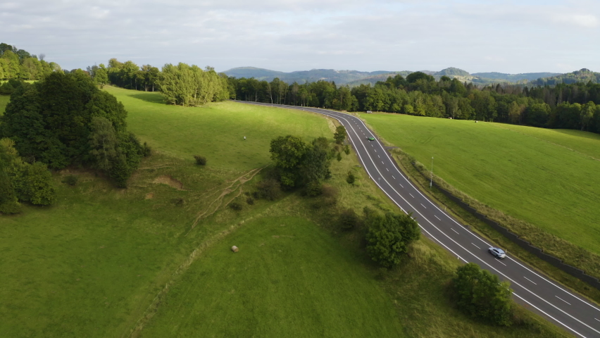 Cars driving on freeway in green grassy countryside in Czechia. | Shutterstock HD Video #1091750057