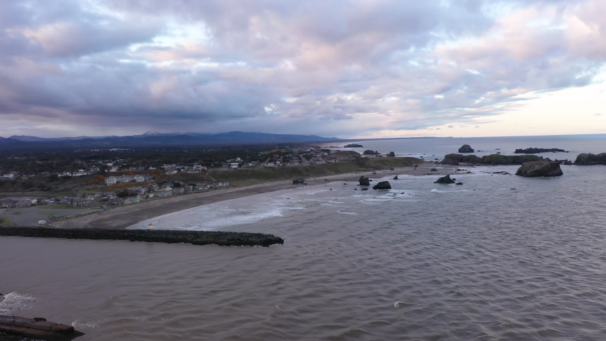 Aerial view of jetties and little fishing town of Bandon, Oregon at dawn.