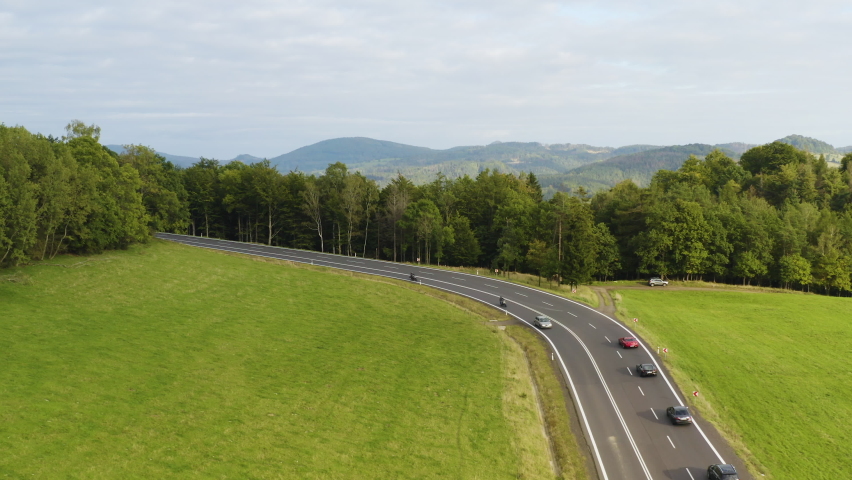 Sports cars fleet driving on bending highway in forests of Czechia. | Shutterstock HD Video #1091750667