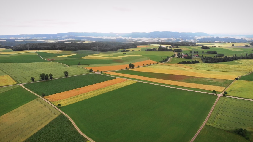 Beautiful agriculture fields. Flying over cultivated yellow and green fields and meadows. Agribusiness concept. Farming and agriculture. Green fields with growing crops and plants