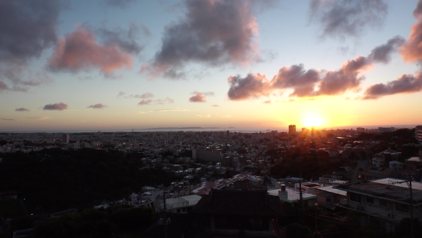 NAHA, OKINAWA, JAPAN - AUG 2021 : Aerial high angle wide view of Naha city in sunset time. Cityscape of downtown area and romantic magic hour sky. Summer holiday, vacation and travel concept video. | Shutterstock HD Video #1091760847
