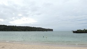 ONNA-SON, OKINAWA, JAPAN - AUGUST 2021 : View of Manza beach (Ocean or sea). Wide view, time lapse shot in sunny daytime. Summer holiday, vacation and resort concept video.