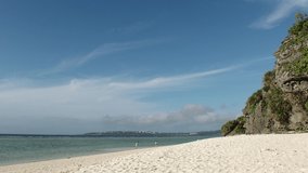 OKINAWA, JAPAN - AUG 2021 : View of Sesoko beach(Ocean or sea) at Sesoko island. Clear blue sunny sky and clouds. Wide view, time lapse shot in day. Summer holiday, vacation and resort concept video.
