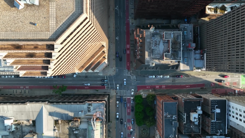Top down aerial above traffic in downtown urban city in USA. Drone above street in American city. Rooftop view visible. Royalty-Free Stock Footage #1091761705